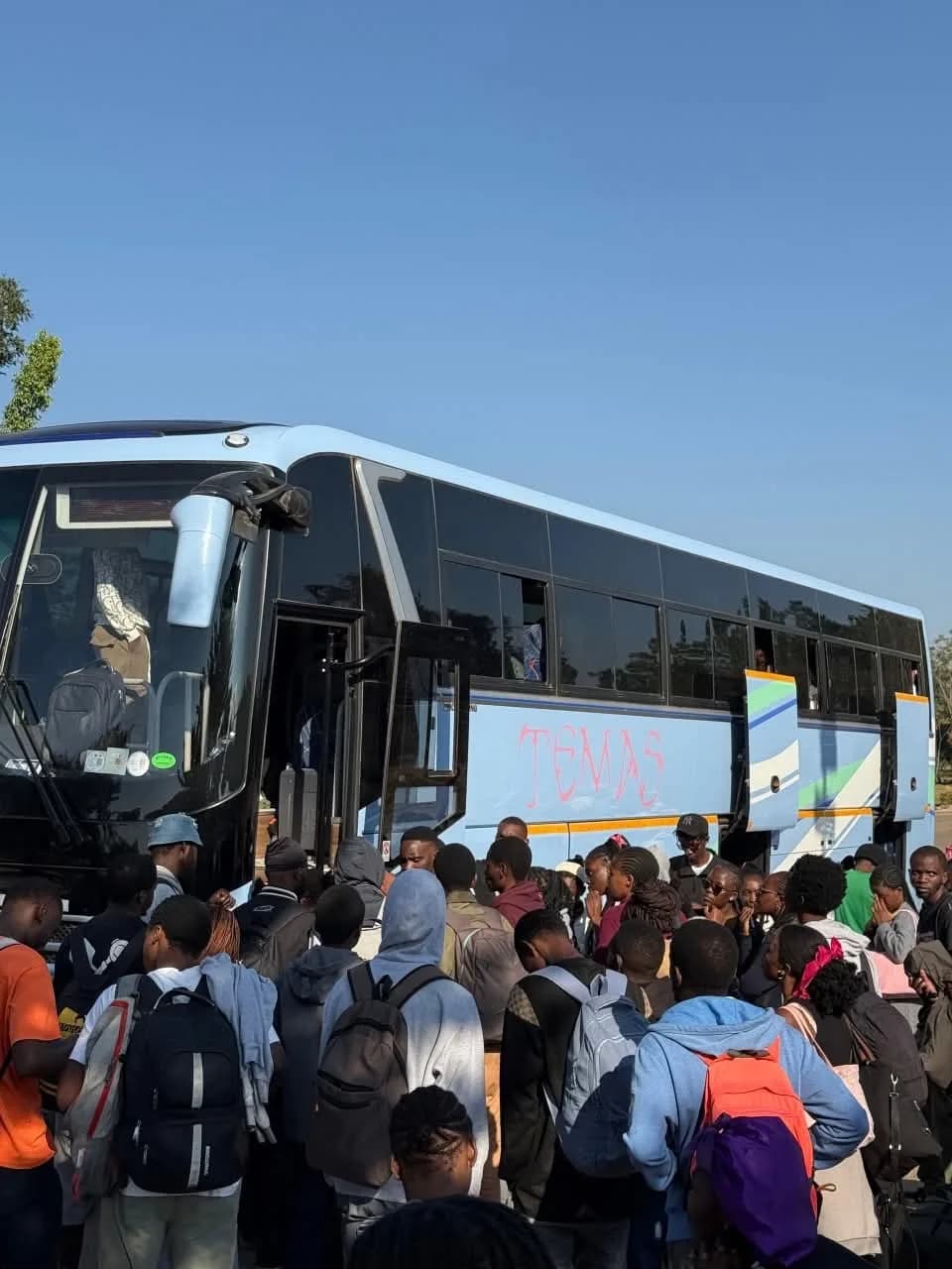 Students gathering to board a campus coach